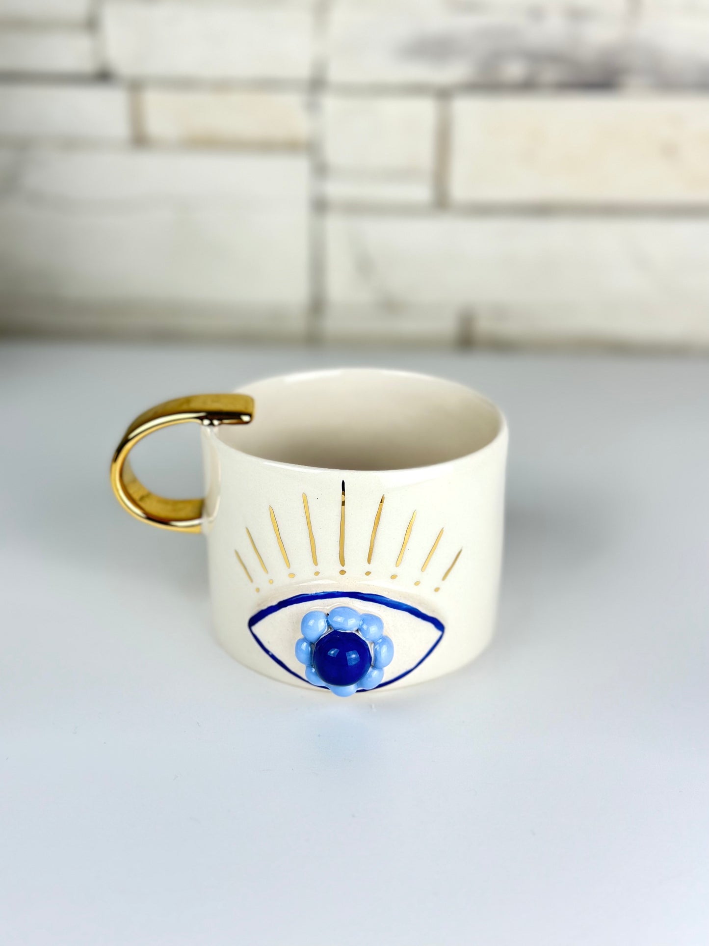 Handgemachte Keramiktasse Evil Eye verziert mit 24 Karat Gold
